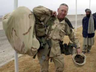 Brig. Gen. James Mattis carries his packs into the Kandahar International Airport in Kandahar, Afghanistan where he will set up operations after arriving Friday, Dec. 14, 2001. The U.S. Marines have taken control of the airfield and have the mission of making it ready to receive fixed wing aircraft. (AP Photo/Dave Martin, Pool)